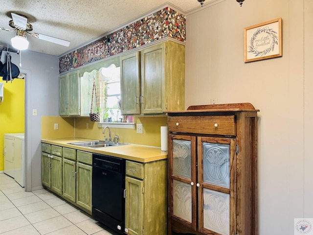 kitchen featuring black dishwasher, washer and clothes dryer, green cabinets, a sink, and a textured ceiling