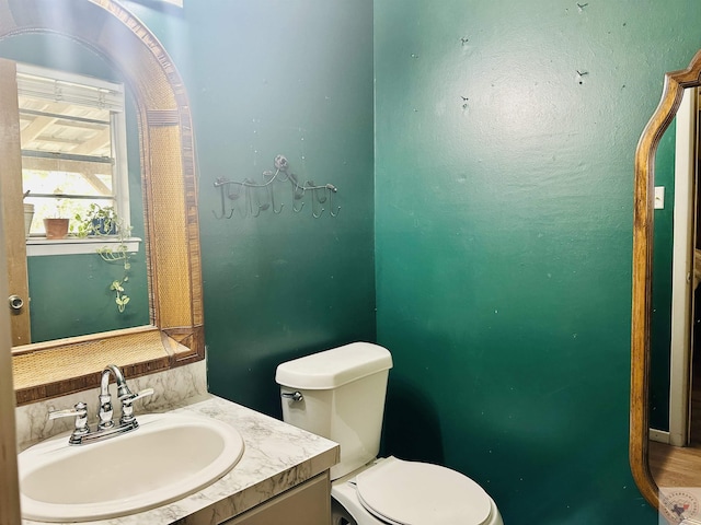 bathroom featuring toilet and vanity