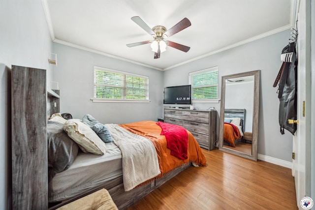 bedroom with light wood-type flooring, crown molding, baseboards, and ceiling fan