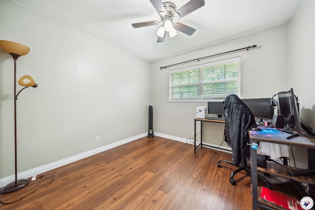 office featuring baseboards, vaulted ceiling, wood finished floors, and ceiling fan