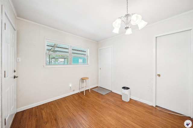 interior space featuring light wood-type flooring, baseboards, ornamental molding, and an inviting chandelier