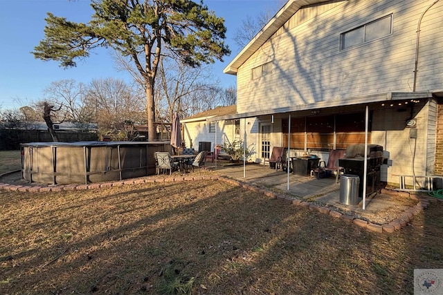 view of yard with a patio area and a covered pool