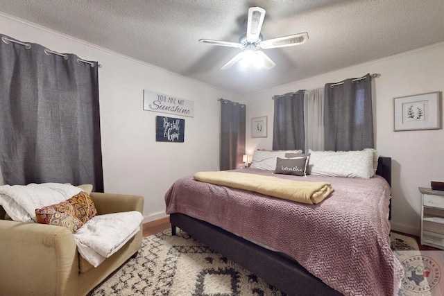 bedroom featuring hardwood / wood-style flooring, a textured ceiling, and ceiling fan