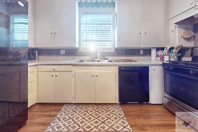 kitchen featuring white cabinetry, sink, wood-type flooring, and stainless steel appliances