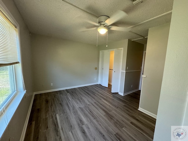 unfurnished bedroom with ceiling fan and dark hardwood / wood-style flooring