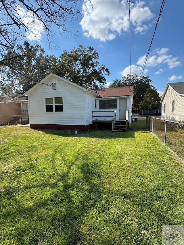 back of house with a yard