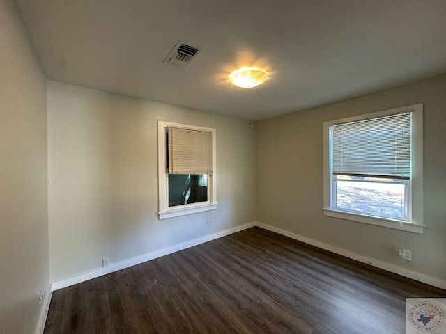 unfurnished room featuring dark hardwood / wood-style flooring