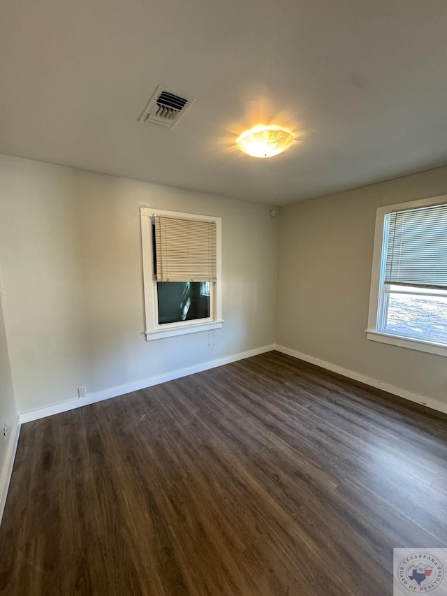 unfurnished room featuring dark hardwood / wood-style flooring