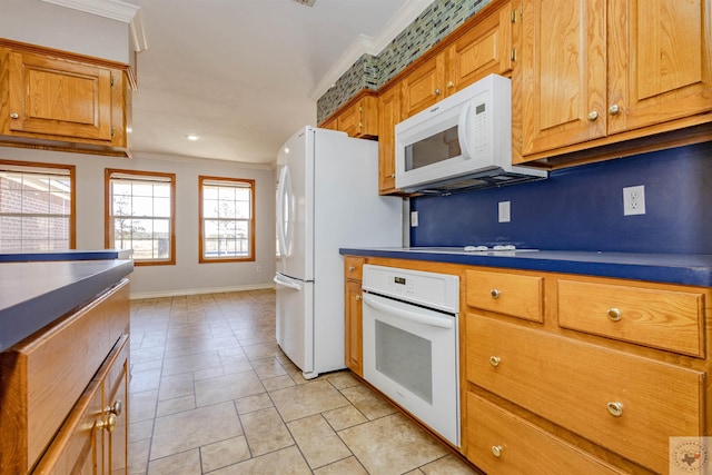 kitchen with ornamental molding, white appliances, and light tile patterned floors