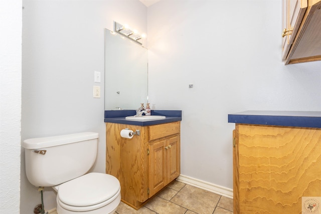 bathroom featuring vanity, tile patterned flooring, and toilet