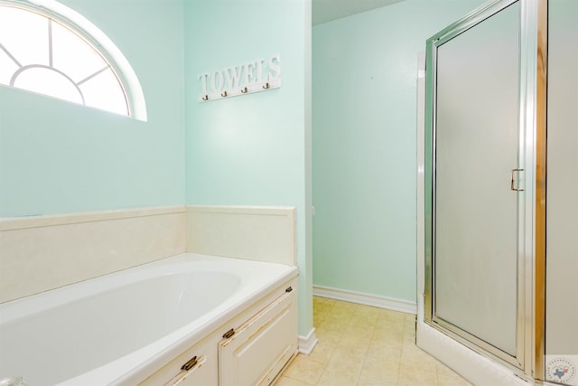 bathroom featuring separate shower and tub