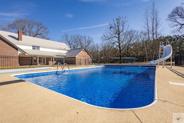 view of swimming pool featuring a patio and a water slide