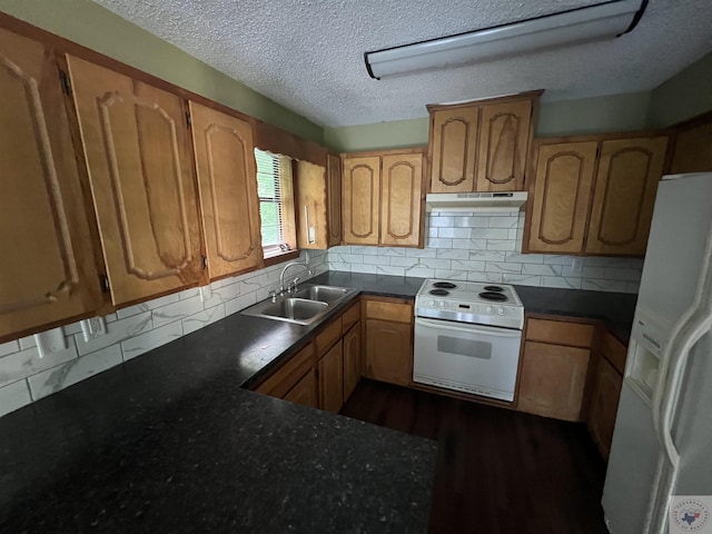 kitchen with sink, white appliances, tasteful backsplash, and a textured ceiling