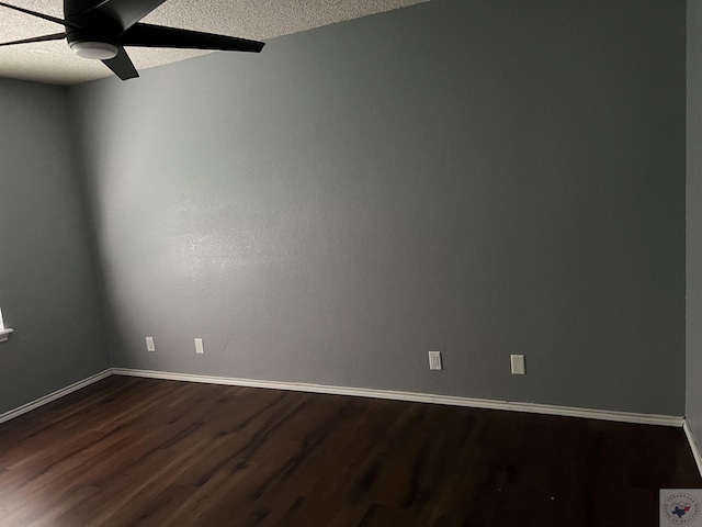 unfurnished room with a textured ceiling, ceiling fan, and dark hardwood / wood-style flooring