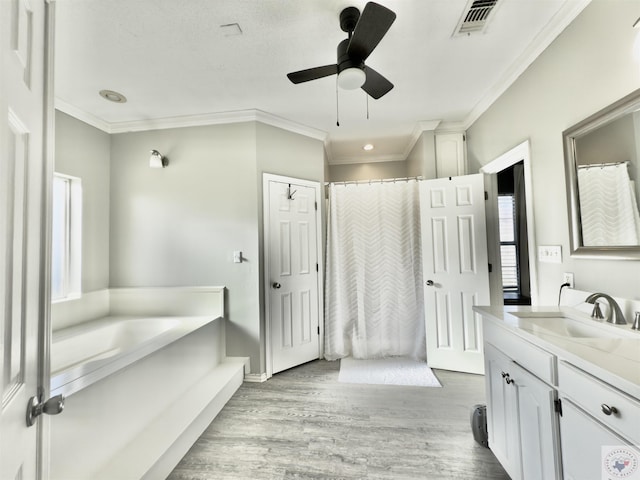full bathroom with wood finished floors, crown molding, ceiling fan, and visible vents