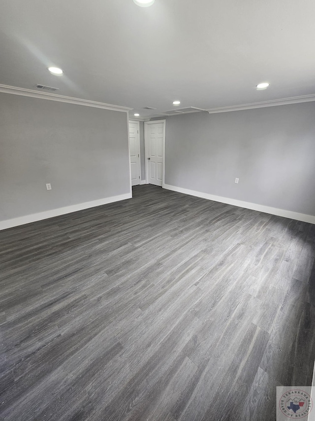 empty room with crown molding and dark hardwood / wood-style flooring