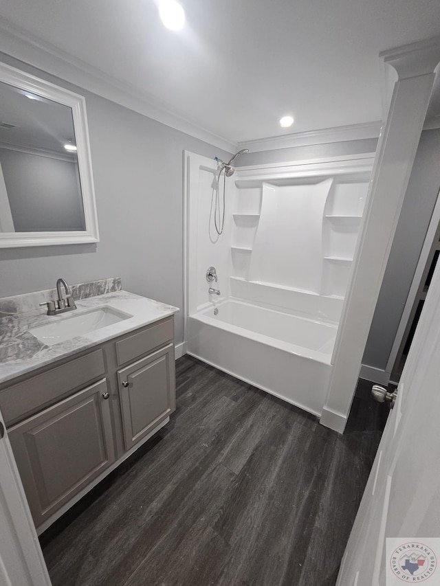 bathroom with tub / shower combination, hardwood / wood-style floors, vanity, and crown molding