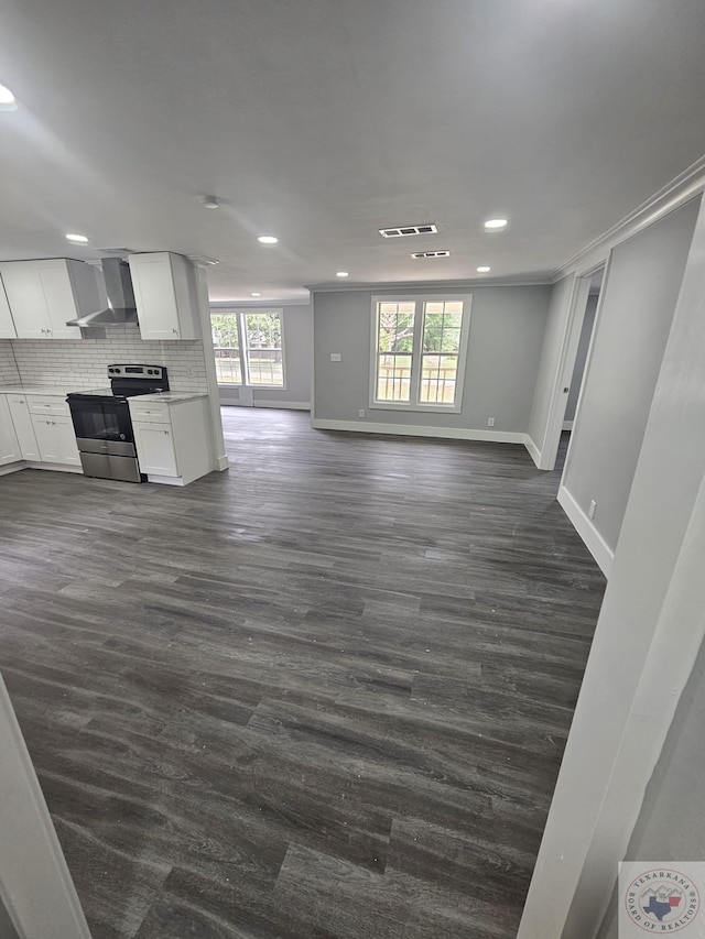 unfurnished living room with dark wood-type flooring and ornamental molding