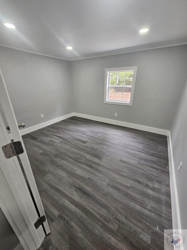 unfurnished room featuring dark wood-type flooring and ornamental molding