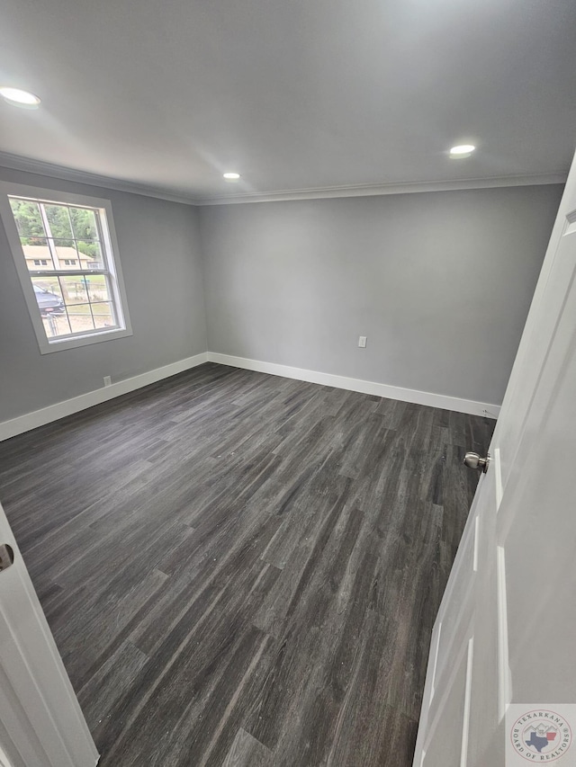 unfurnished room with dark wood-type flooring and ornamental molding