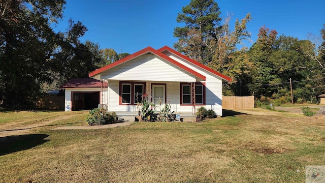 bungalow-style home featuring a porch, a garage, and a front lawn