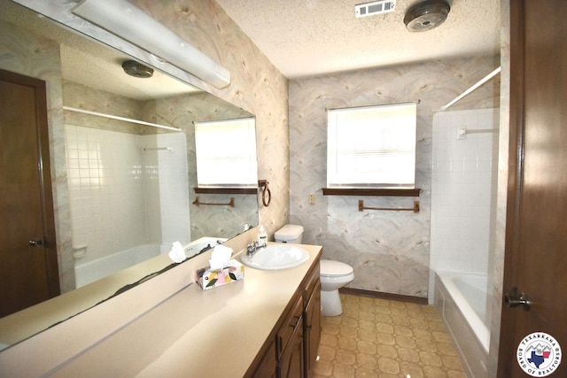 1104A E 23rd St, Texarkana, AR 71854 - full bathroom with plenty of natural light, vanity,  shower combination, tile patterned floors, and a textured ceiling
