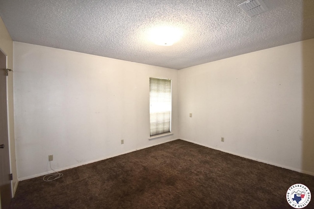 1104A E 23rd St, Texarkana, AR 71854 - empty room featuring dark colored carpet and a textured ceiling