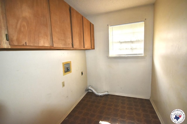 1104A E 23rd St, Texarkana, AR 71854 - washroom with hookup for a washing machine, cabinet space, dark flooring, and hookup for an electric dryer