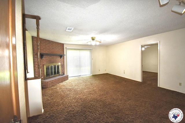 1104A E 23rd St, Texarkana, AR 71854 - unfurnished living room featuring ceiling fan, carpet flooring, a textured ceiling, and a brick fireplace