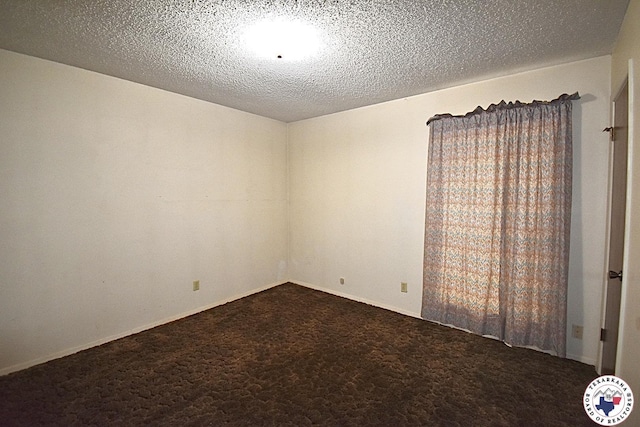 1104A E 23rd St, Texarkana, AR 71854 - empty room with carpet flooring and a textured ceiling