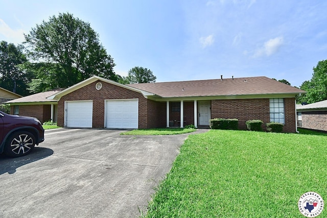 1104A E 23rd St, Texarkana, AR 71854 - ranch-style house featuring a front yard, an attached garage, asphalt driveway, and brick siding