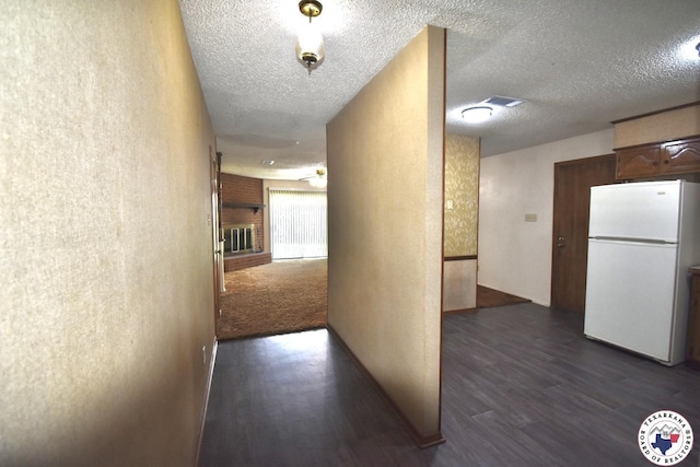 1104A E 23rd St, Texarkana, AR 71854 - hall with dark wood-style flooring, a textured ceiling, and a textured wall
