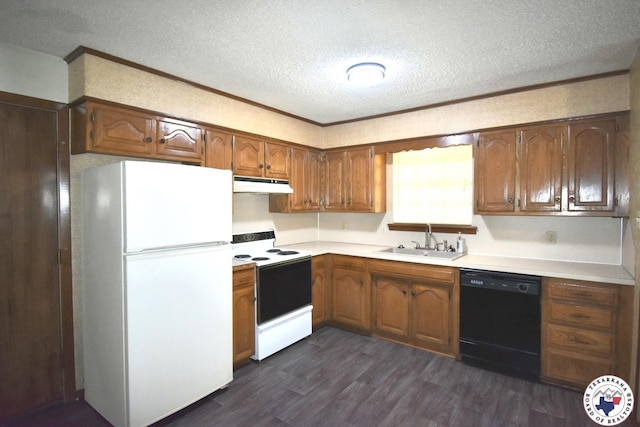 1104A E 23rd St, Texarkana, AR 71854 - kitchen with white appliances, under cabinet range hood, a textured ceiling, dark wood finished floors, and brown cabinets