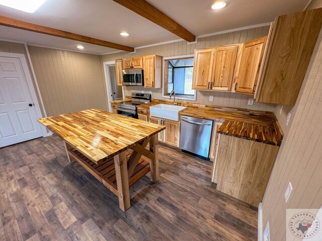 kitchen featuring light brown cabinetry, dark hardwood / wood-style flooring, sink, beam ceiling, and stainless steel appliances