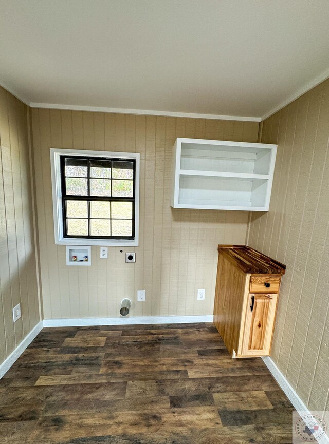 clothes washing area featuring washer hookup, dark hardwood / wood-style flooring, ornamental molding, and electric dryer hookup