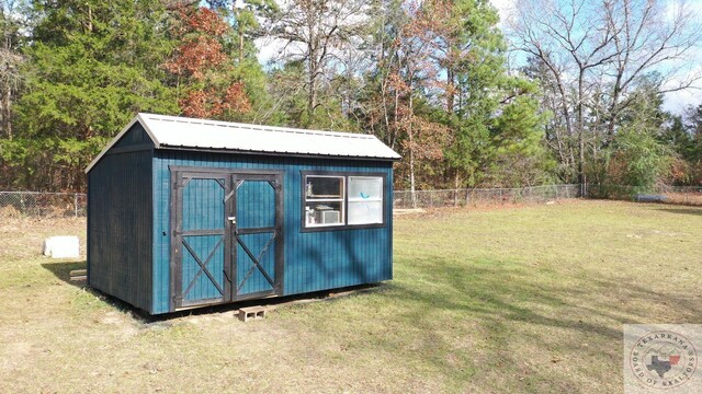 view of outbuilding featuring a lawn