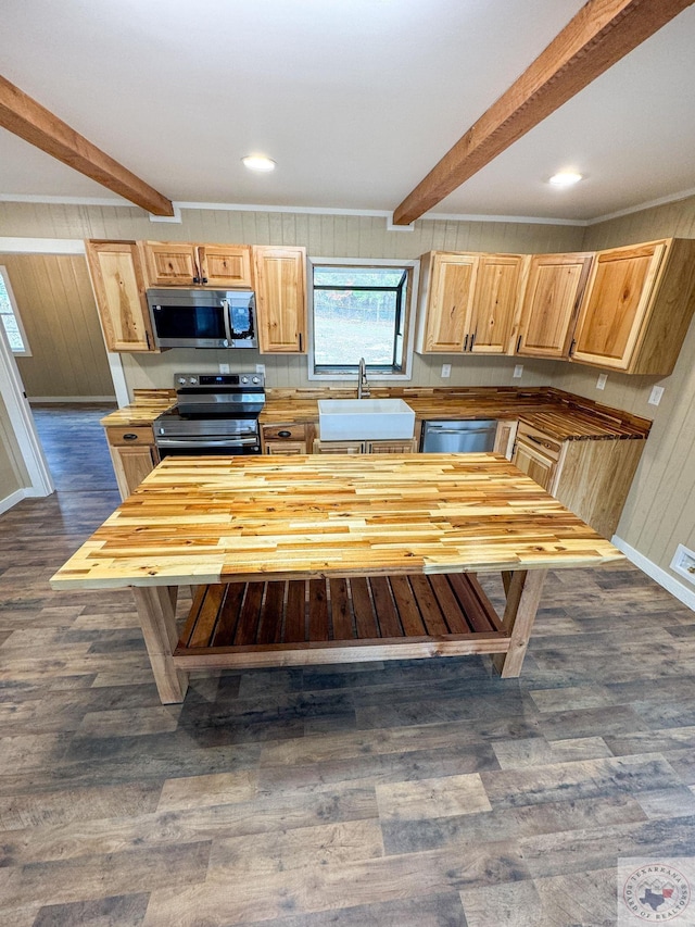 kitchen featuring beamed ceiling, sink, dark wood-type flooring, stainless steel appliances, and wood counters