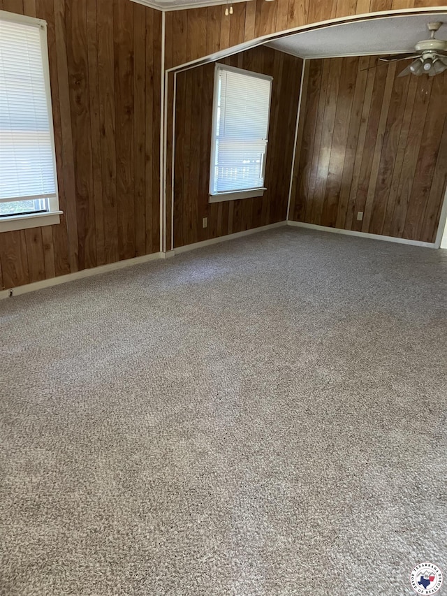 319 Crestview Rd, Texarkana, TX 75501 - empty room with wooden walls, a ceiling fan, and carpet floors