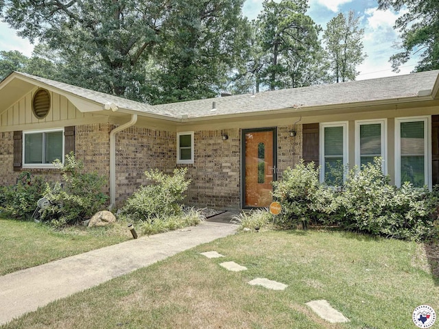 43 Broadmoor Dr, Texarkana, AR 78154 - ranch-style home with a front yard, board and batten siding, brick siding, and a shingled roof