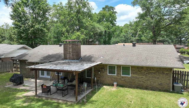 43 Broadmoor Dr, Texarkana, AR 78154 - back of property with a chimney, roof with shingles, brick siding, and a patio