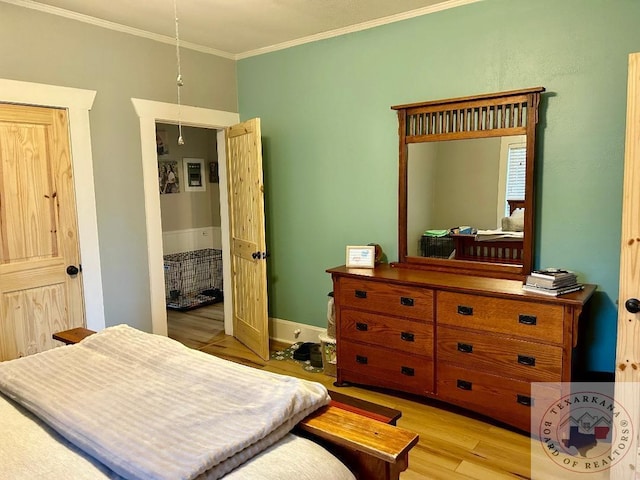 bedroom featuring light hardwood / wood-style flooring and ornamental molding