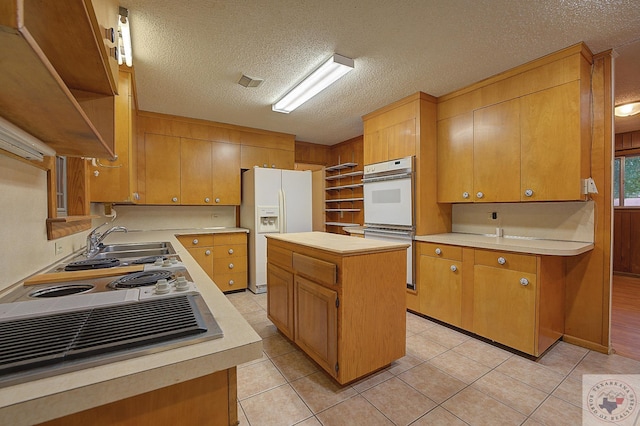 6504 Scott Wright Rd, Texarkana, TX 75503 - kitchen with white appliances, a textured ceiling, open shelves, and light countertops