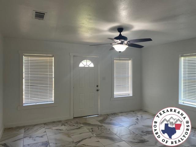 104 Pecan St, Atlanta, TX 75551 - entrance foyer with marble look tile flooring and ceiling fan