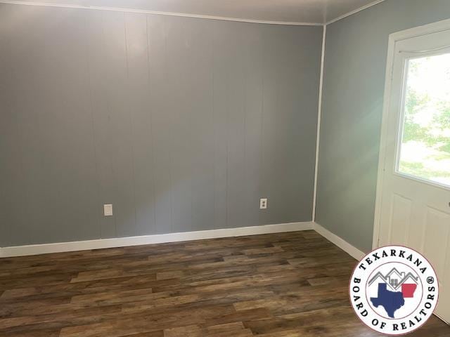104 Pecan St, Atlanta, TX 75551 - spare room with dark wood-style floors, baseboards, plenty of natural light, and ornamental molding