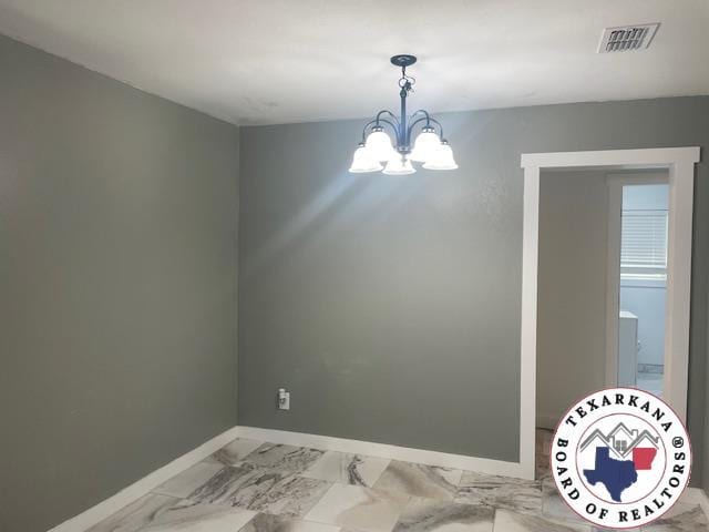 104 Pecan St, Atlanta, TX 75551 - unfurnished room with baseboards, a chandelier, and light marble finish floors