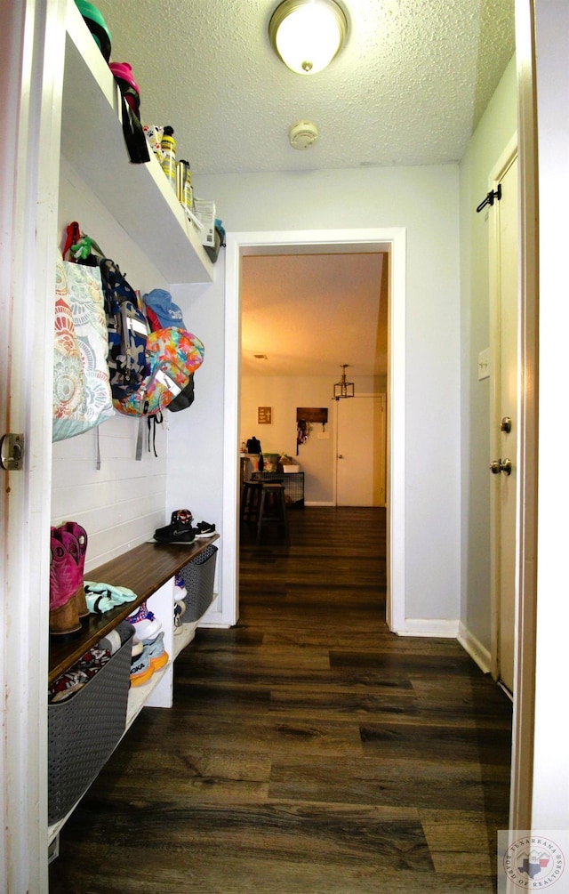 mudroom featuring a textured ceiling and dark hardwood / wood-style flooring