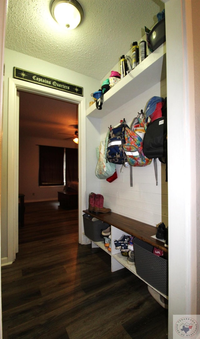 mudroom with a textured ceiling and dark hardwood / wood-style flooring