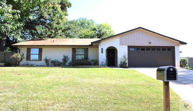 single story home with a garage and a front yard