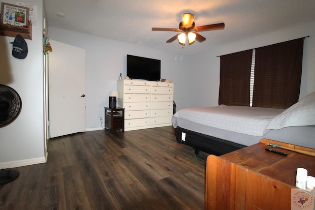 bedroom with ceiling fan and dark wood-type flooring