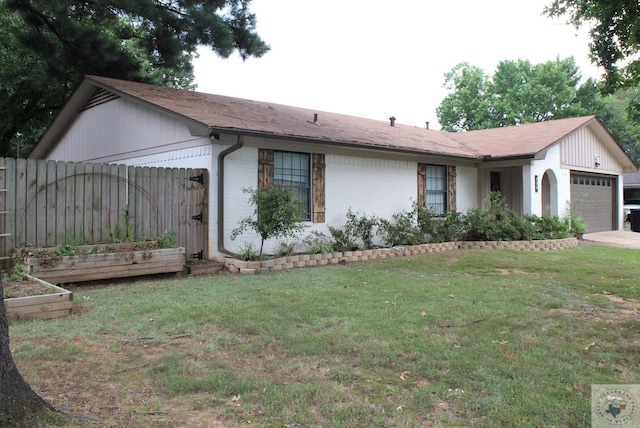 ranch-style home with a garage and a front lawn